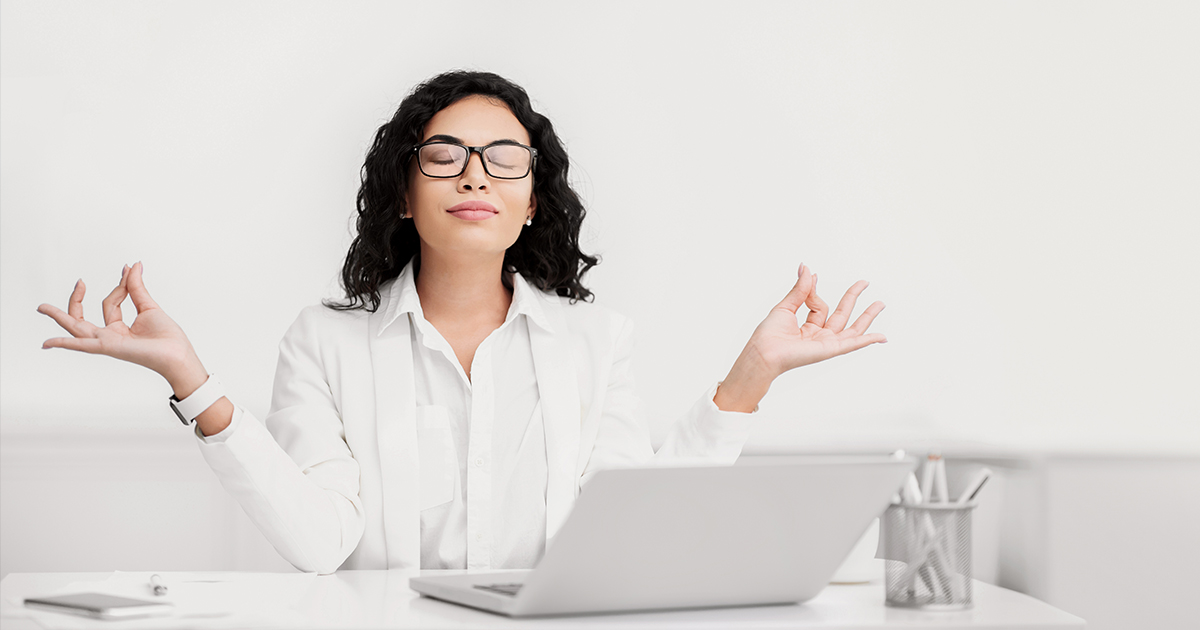 a woman dressed in white manages stress through meditation