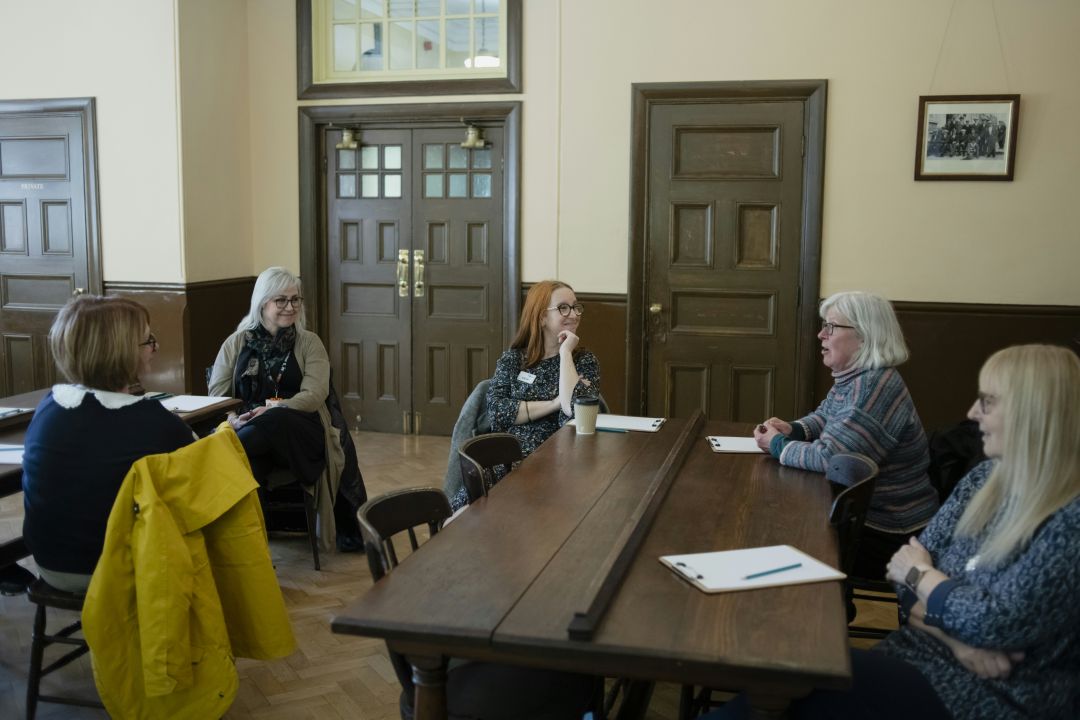 a group of women having a discussion, illustrating an example of a mini-culture