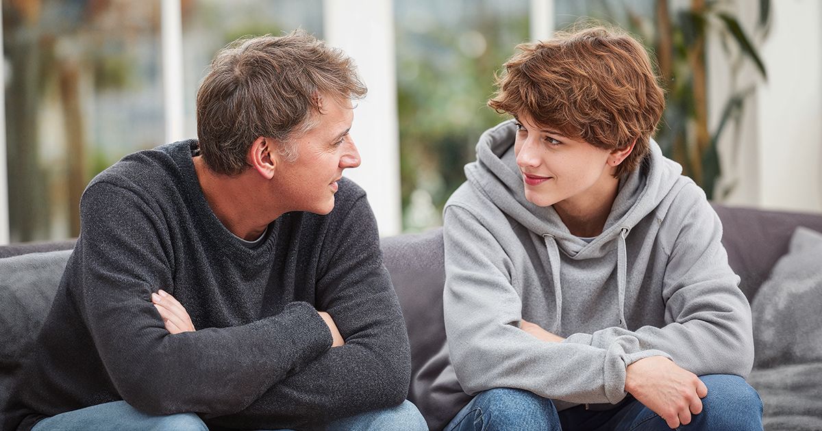 two individuals have a conversation on a couch, exhibiting emotional logic